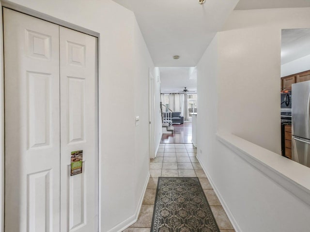 hall with light tile patterned flooring