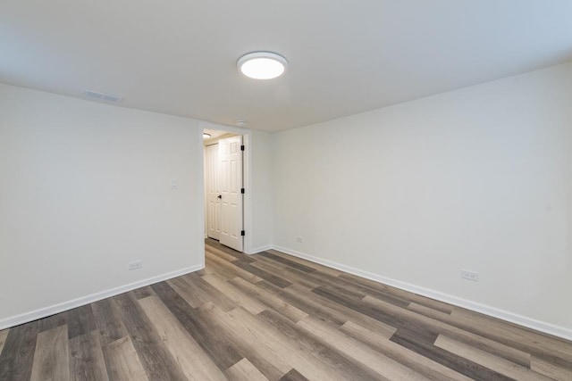 empty room with dark hardwood / wood-style floors