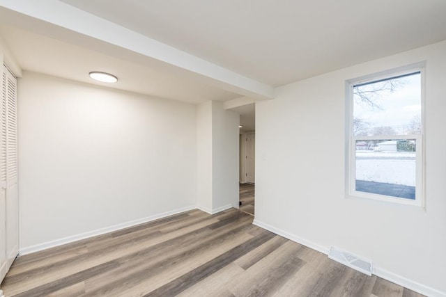 spare room with wood-type flooring