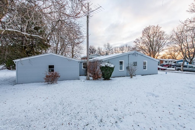 view of snow covered back of property