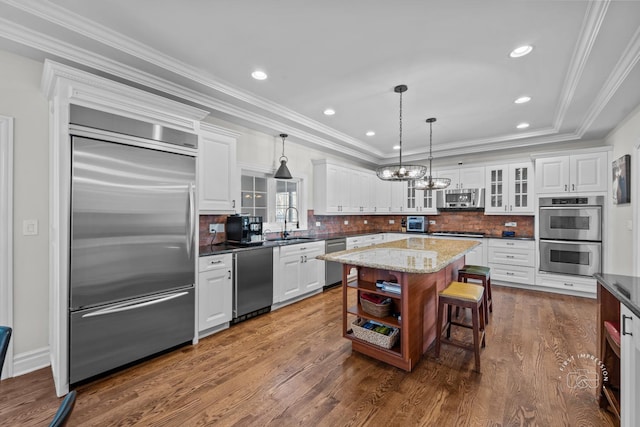 kitchen featuring glass insert cabinets, appliances with stainless steel finishes, open shelves, and white cabinets