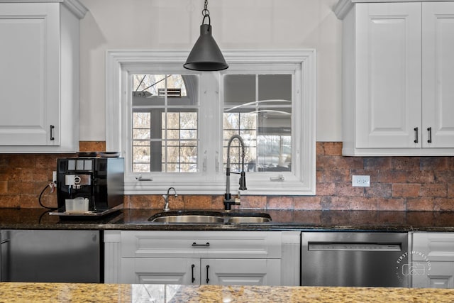 kitchen featuring a sink, dark stone countertops, white cabinets, and stainless steel dishwasher