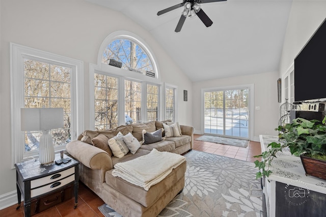 tiled living room with baseboards, high vaulted ceiling, and a ceiling fan