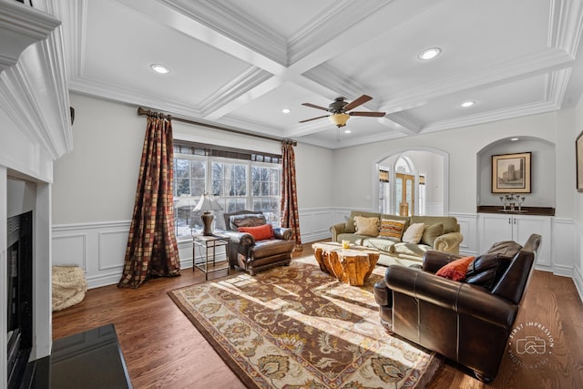 living area with beam ceiling, coffered ceiling, and a fireplace