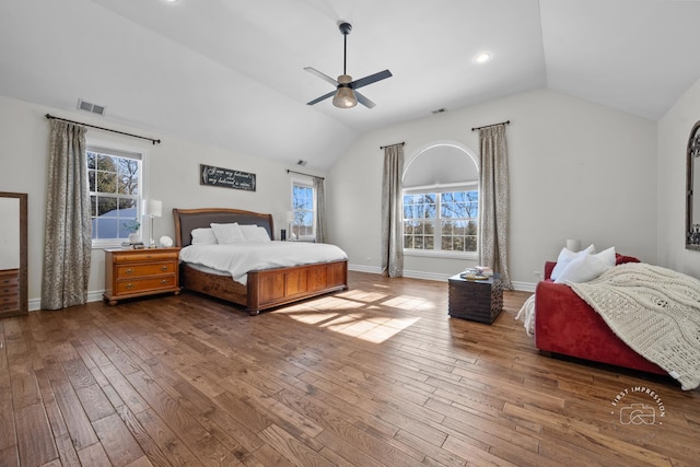 bedroom featuring baseboards, visible vents, vaulted ceiling, and dark wood-style flooring