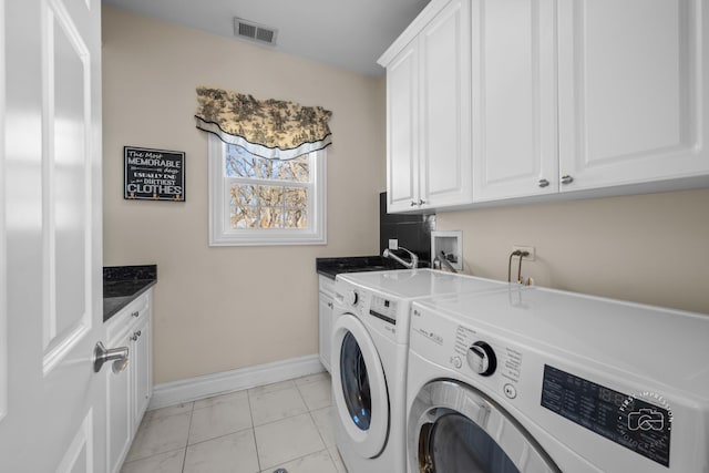 clothes washing area featuring a sink, visible vents, baseboards, washer and dryer, and cabinet space