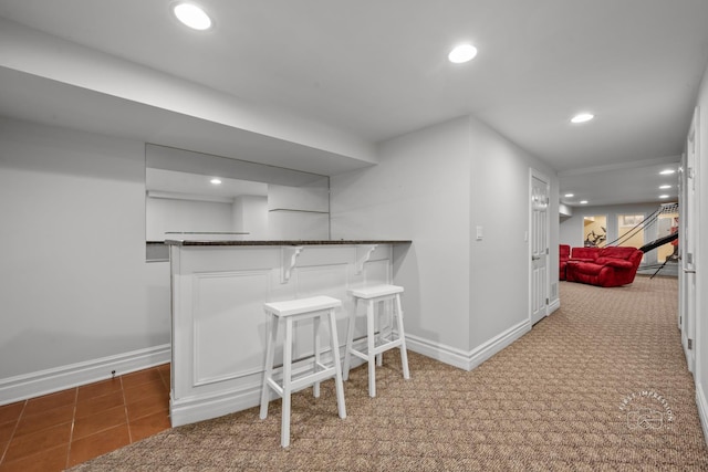 bar with baseboards, dark colored carpet, a dry bar, and recessed lighting