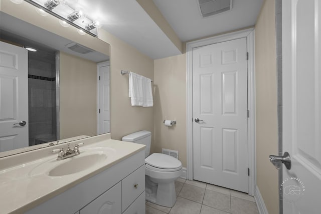 bathroom with visible vents, vanity, toilet, and tile patterned floors