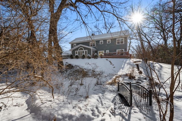 view of snow covered rear of property