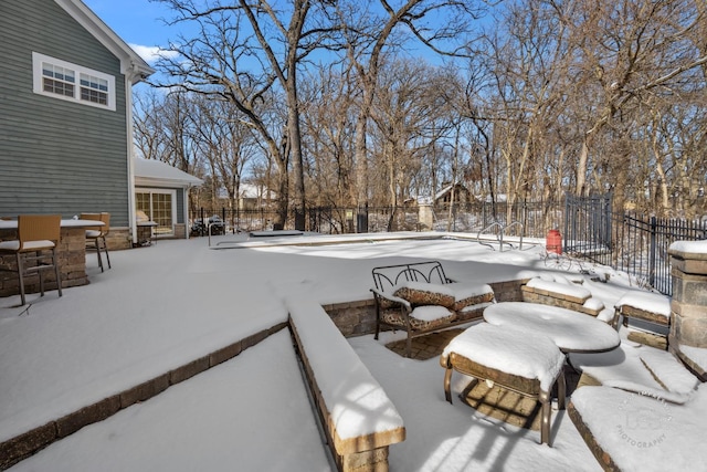 snow covered patio with fence