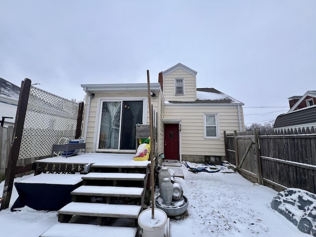 view of snow covered back of property