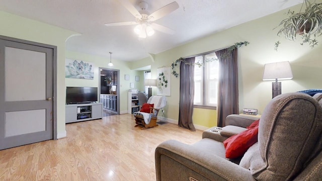 living room with ceiling fan and light wood-type flooring