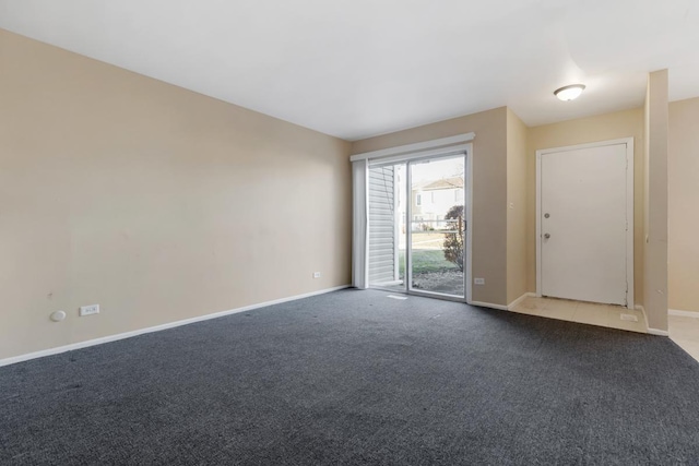 spare room featuring light carpet