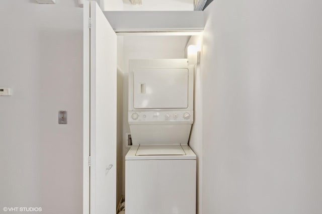 laundry area featuring stacked washer / dryer