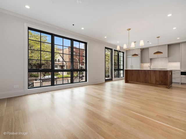 1208 W Wellington St Unit 1F, Chicago, IL 60657 - unfurnished living room featuring recessed lighting, baseboards, and light wood-style flooring