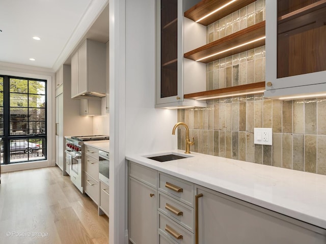 1208 W Wellington St Unit 1F, Chicago, IL 60657 - kitchen featuring a sink, stainless steel range, gray cabinets, and light wood finished floors