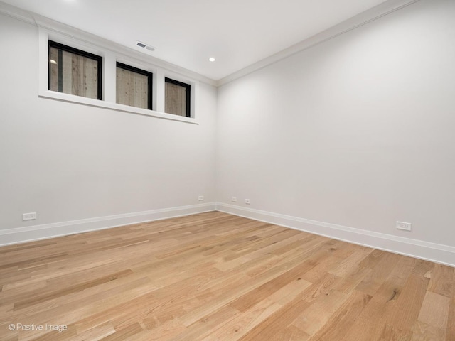 1208 W Wellington St Unit 1F, Chicago, IL 60657 - spare room featuring baseboards, light wood finished floors, crown molding, and visible vents