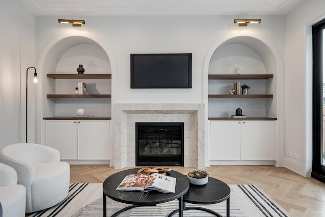 living room with a fireplace and built in features