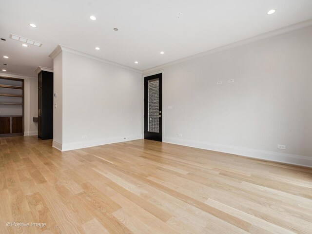 1208 W Wellington St Unit 1F, Chicago, IL 60657 - spare room with baseboards, visible vents, ornamental molding, and light wood finished floors