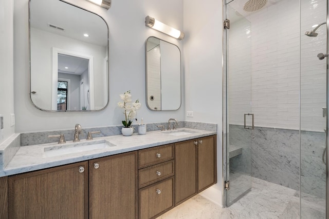 bathroom featuring a stall shower, visible vents, a sink, and double vanity