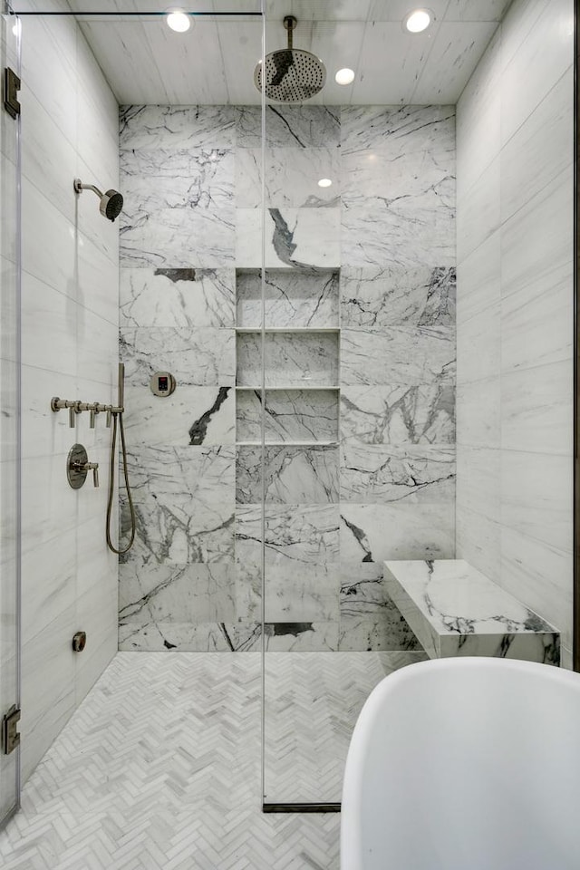 bathroom featuring recessed lighting, a freestanding bath, and a marble finish shower