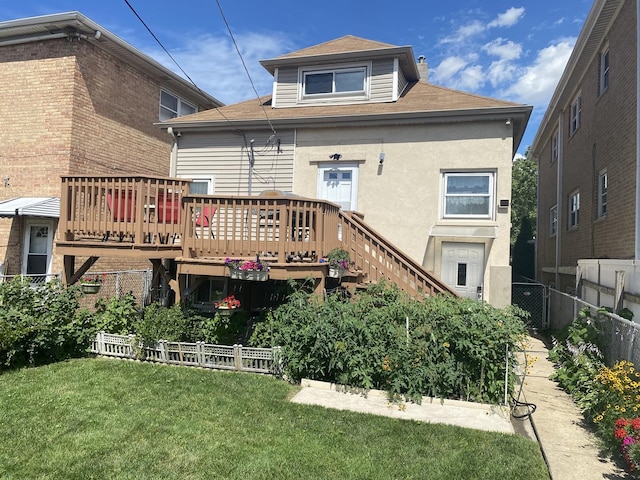 back of property with a yard and a wooden deck