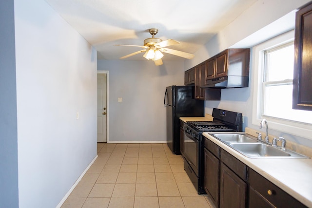 kitchen with light tile patterned flooring, sink, ceiling fan, dark brown cabinets, and gas stove