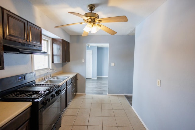 kitchen featuring black range with gas cooktop, dark brown cabinets, ceiling fan, sink, and light tile patterned floors