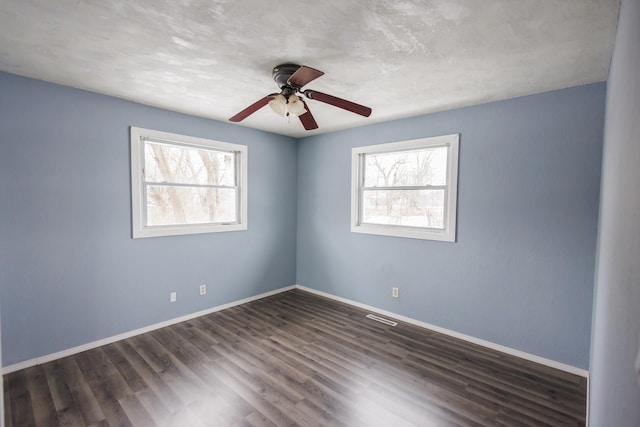 spare room with ceiling fan and dark hardwood / wood-style floors