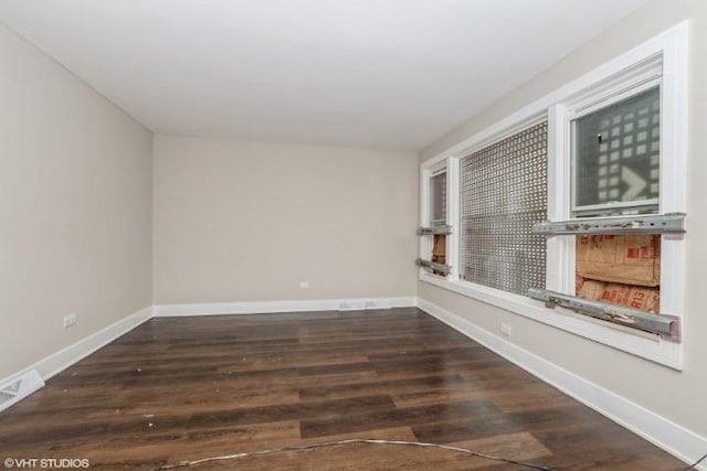 spare room featuring dark wood-type flooring