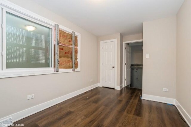 unfurnished bedroom with ceiling fan and dark hardwood / wood-style floors