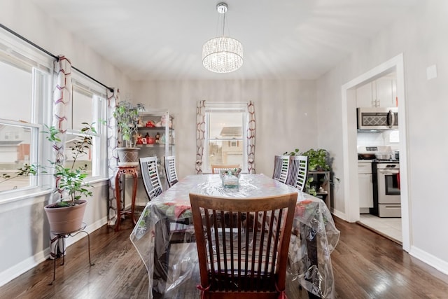 dining area with dark hardwood / wood-style flooring and a notable chandelier