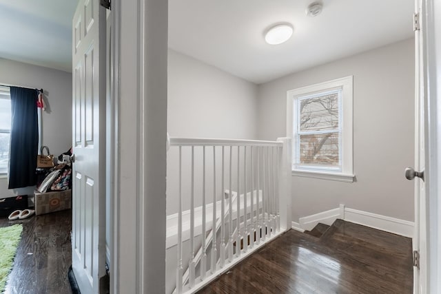 hallway with dark hardwood / wood-style flooring