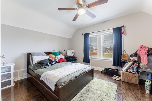 bedroom featuring ceiling fan, dark hardwood / wood-style floors, and vaulted ceiling