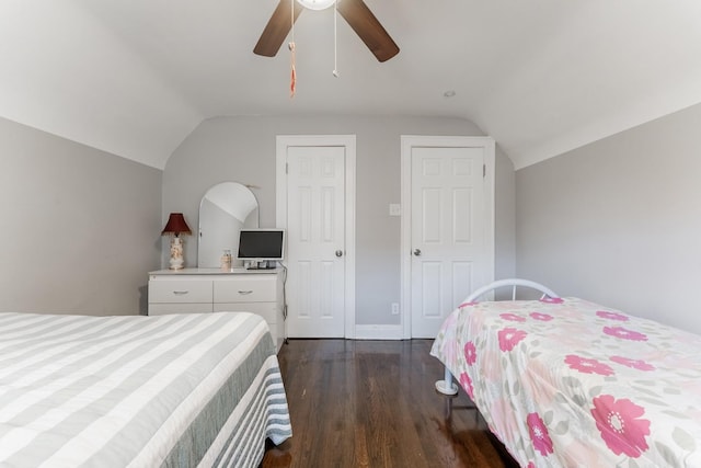 bedroom featuring ceiling fan, dark wood-type flooring, and vaulted ceiling