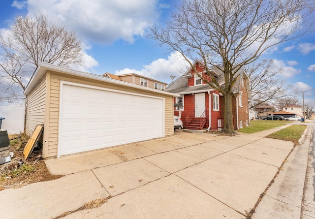 view of front of property featuring a garage and an outdoor structure