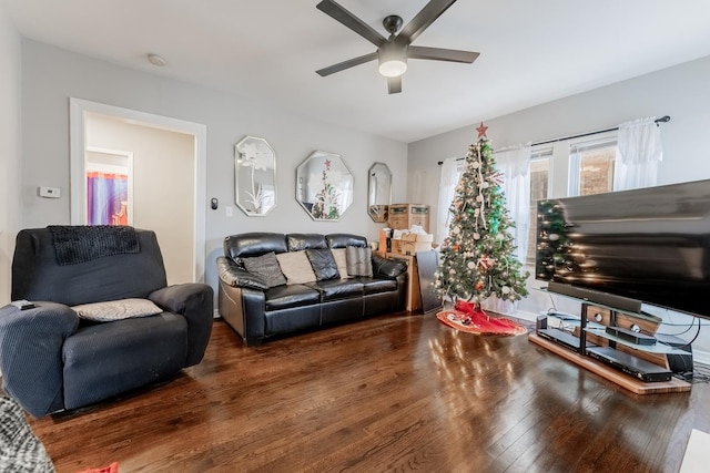 living room featuring dark hardwood / wood-style flooring and ceiling fan