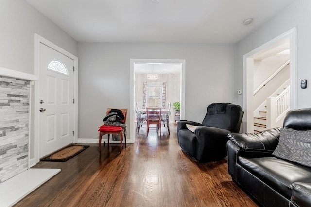 foyer entrance with a chandelier and dark wood-type flooring