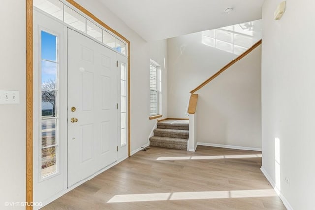 foyer with light hardwood / wood-style floors and a healthy amount of sunlight