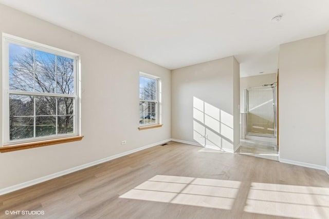 spare room with light hardwood / wood-style floors