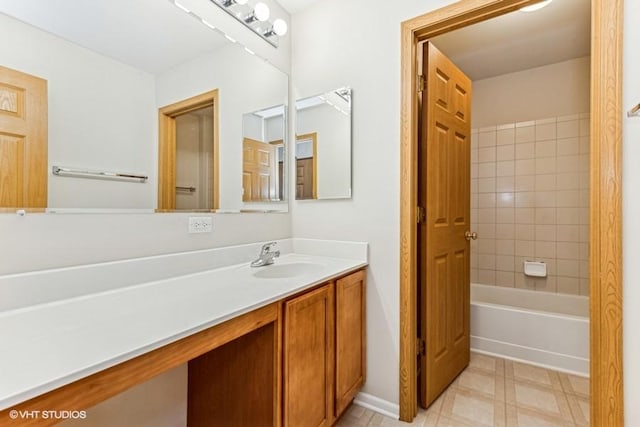 bathroom featuring vanity and tiled shower / bath