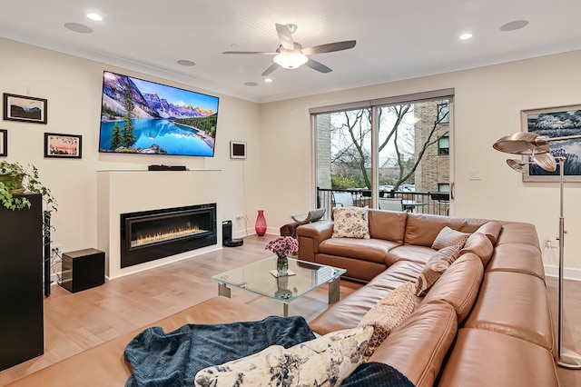 living room featuring ceiling fan and light wood-type flooring