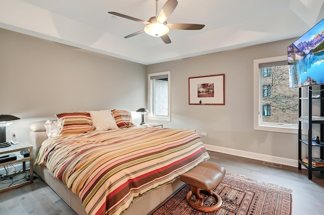 bedroom with hardwood / wood-style flooring and ceiling fan