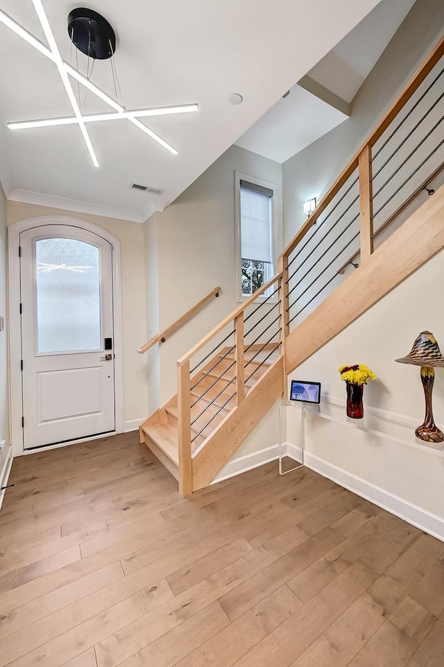 stairway with hardwood / wood-style floors and plenty of natural light