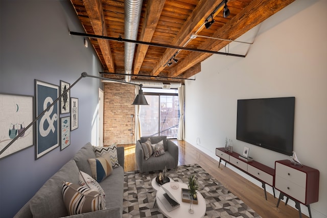 living room with beamed ceiling, wooden ceiling, and hardwood / wood-style flooring