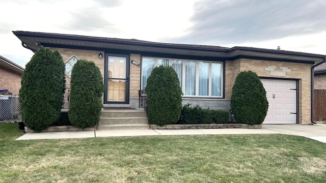 view of front of house featuring a garage and a front lawn