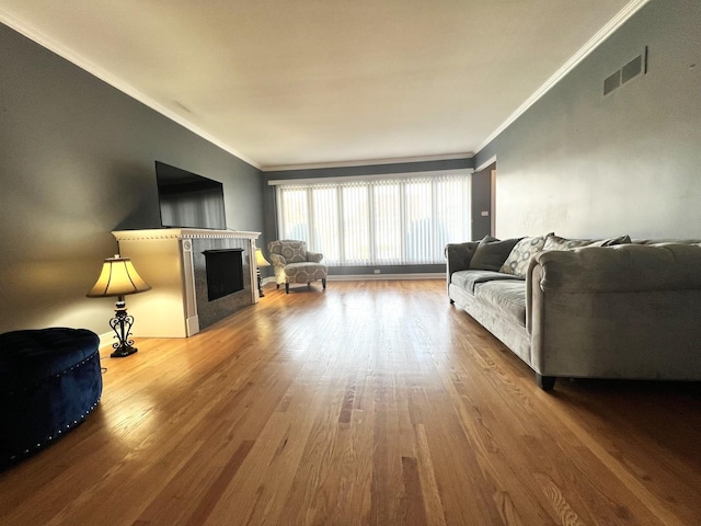 living room with hardwood / wood-style floors and ornamental molding