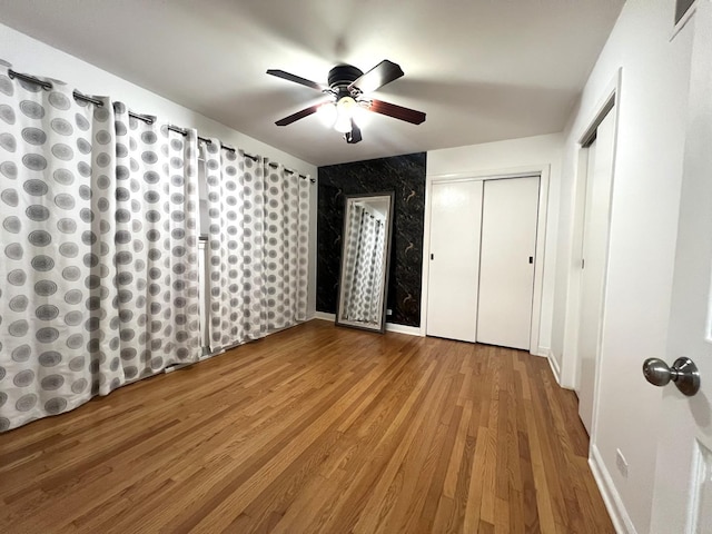 unfurnished bedroom with hardwood / wood-style flooring and ceiling fan