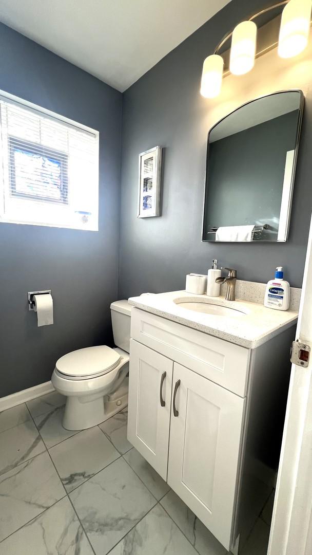 bathroom featuring vanity and toilet