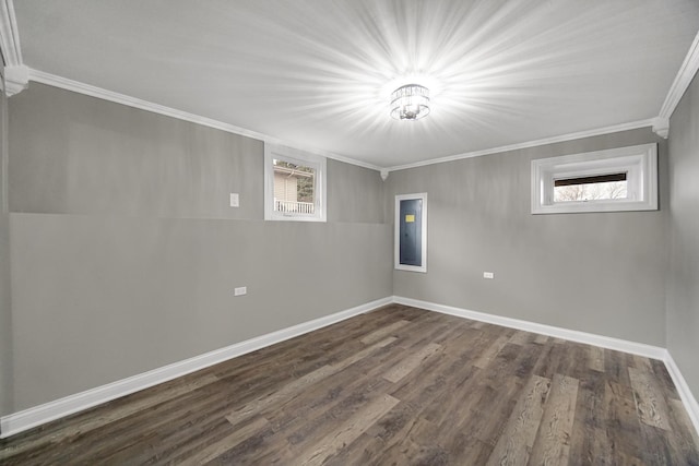 spare room featuring crown molding and dark wood-type flooring